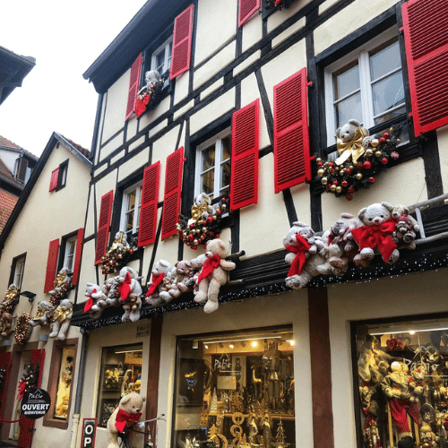 Façade à colombages décorée de guirlandes et d’ours en peluche pour Noël à Obernai, en Alsace.